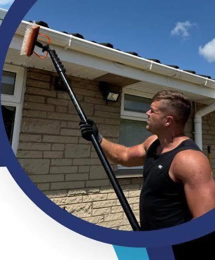 Ash cleaning upstairs windows with a water-fed pole.